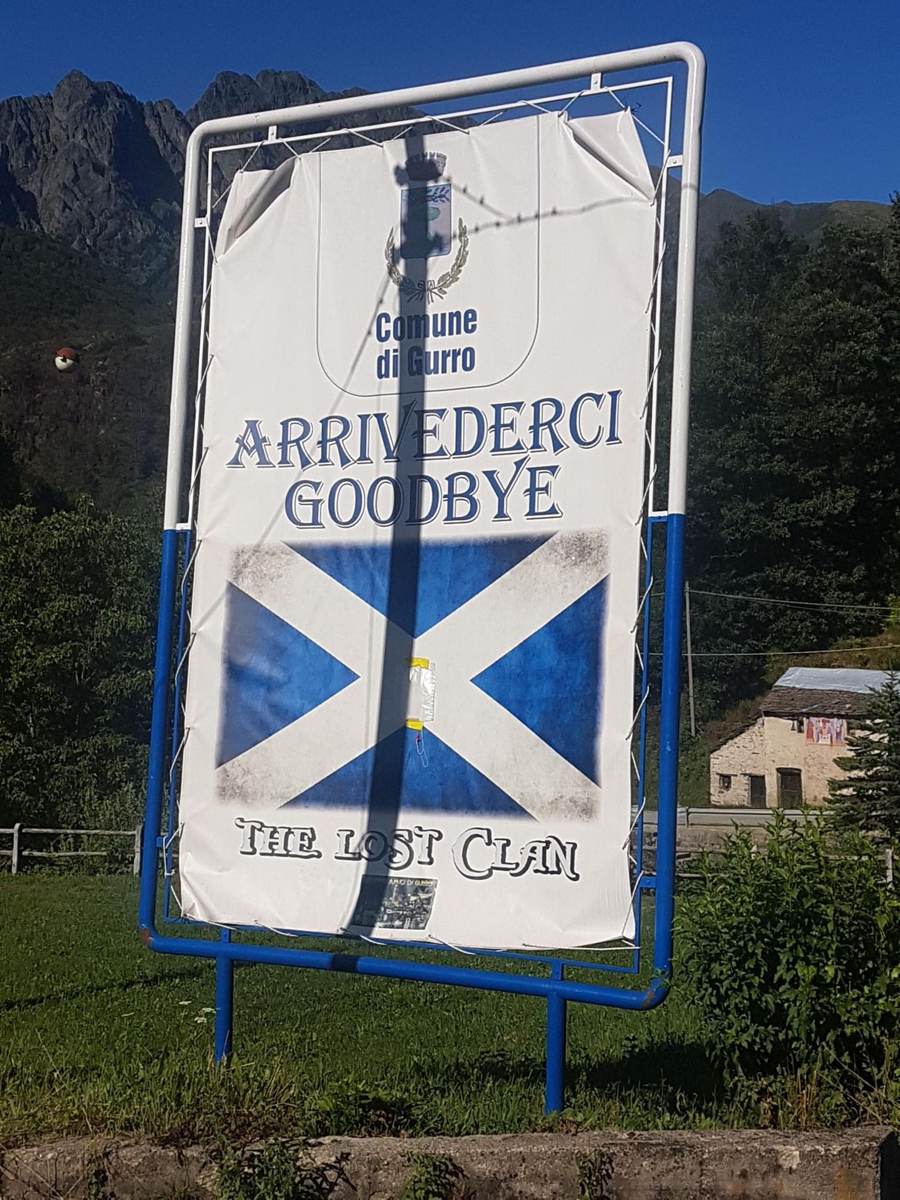 Sign reading Arrivederci Scotland Goodbye The Last Climb with a Saltire flag, on a route near Cannobio