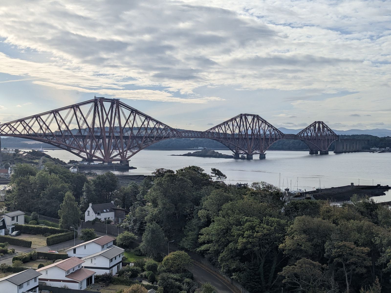 The Forth Rail Bridge seen across the water from the Fife shore on a bright morning