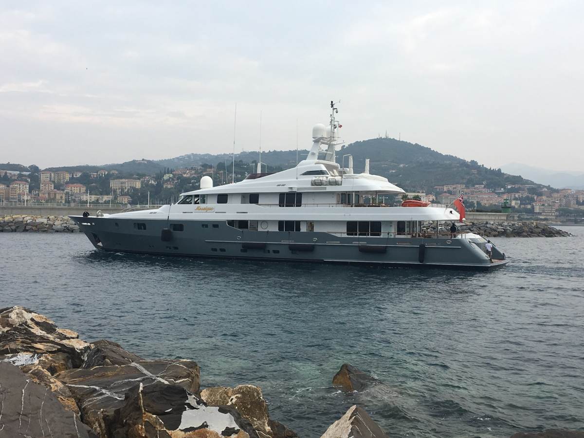 A large yacht moored in Porto Maurizio harbour, Imperia, at dusk
