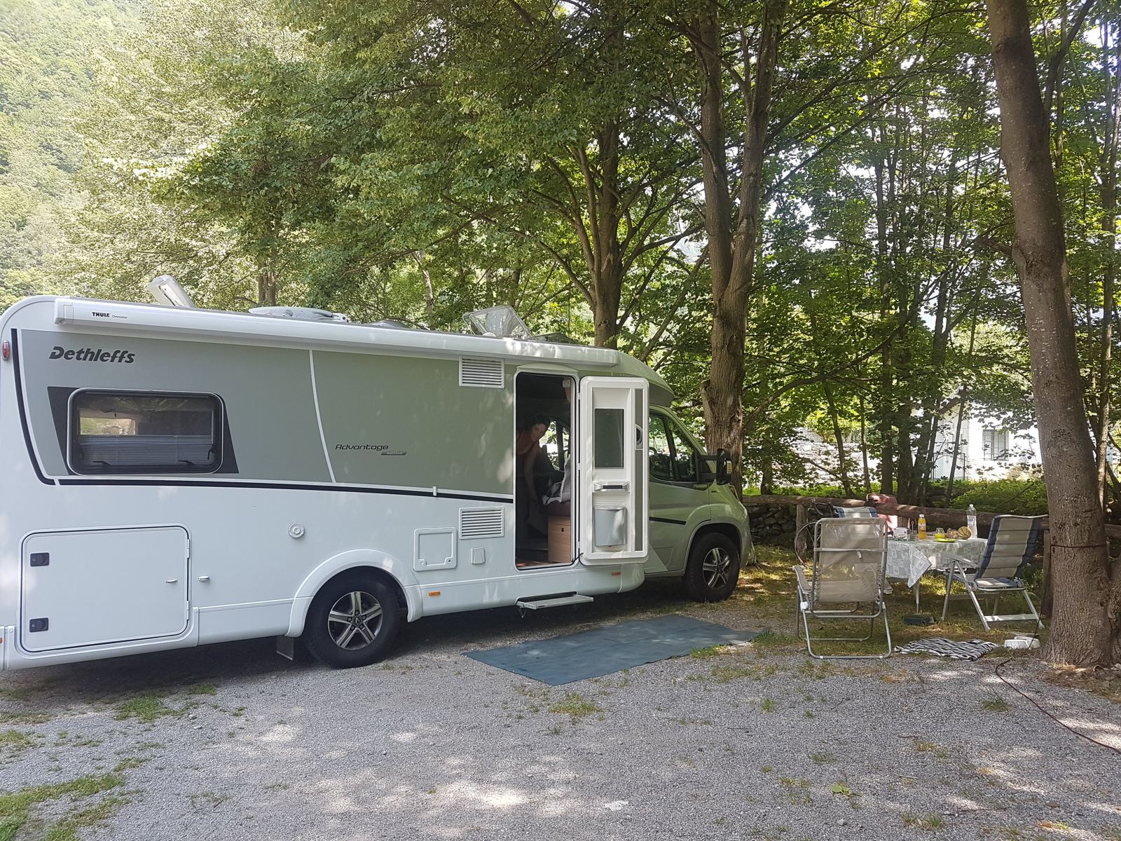 My Dethleffs motorhome parked at a shaded riverside campsite in the Verzasca Valley